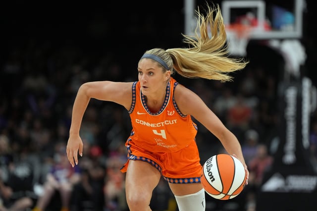 Aug 5, 2025; Phoenix, Arizona, USA; Connecticut Sun guard Jacy Sheldon (4) drives against the Phoenix Mercury in the second half at Footprint Center. Mandatory Credit: Rick Scuteri-Imagn Images