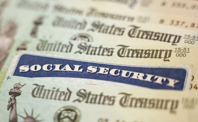 In this photo illustration, a Social Security card sits alongside checks from the U.S. Treasury on October 14, 2021 in Washington, DC.