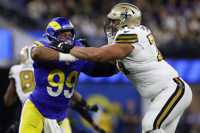INGLEWOOD, CA - DECEMBER 21: Aaron Donald #99 of the Los Angeles Rams runs around the edge as Andrus Peat #75 of the New Orleans Saints blocks during the first half of the game at SoFi Stadium on December 21, 2023 in Inglewood, California.
