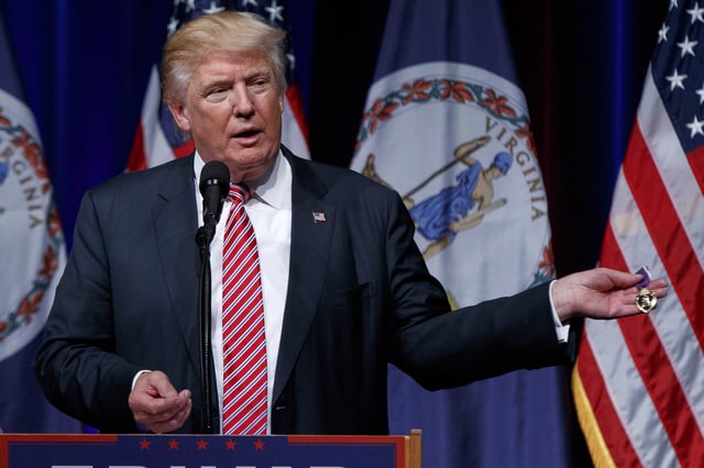FILE - Republican presidential candidate Donald Trump holds a Purple Heart medal given to him by a supporter during a campaign rally, Aug. 2, 2016, in Ashburn, Va. (AP Photo/Evan Vucci, File)