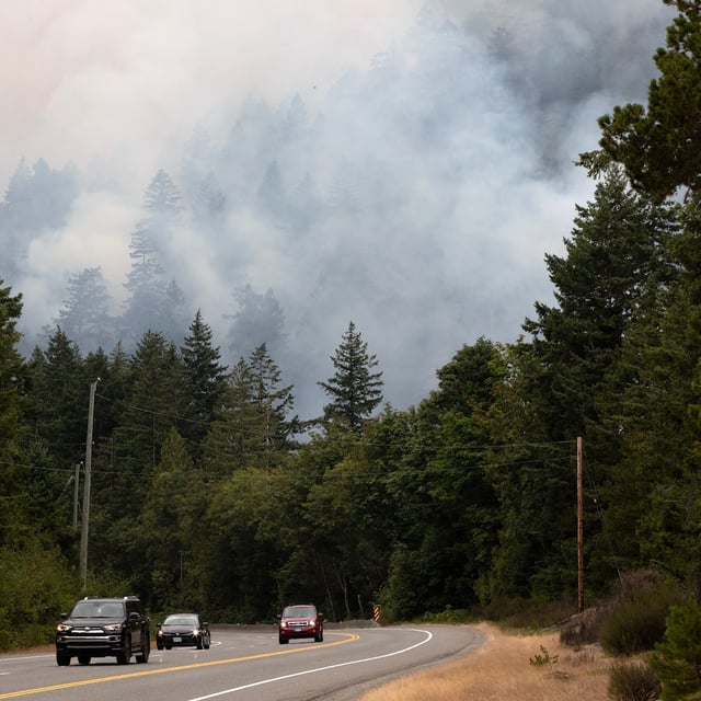 Traffic leaves the area along highway 4 below the Wesley Ridge wildfire at Cameron Lake near Coombs, B.C., on Sunday, August 3, 2025. THE CANADIAN PRESS/Chad Hipolito