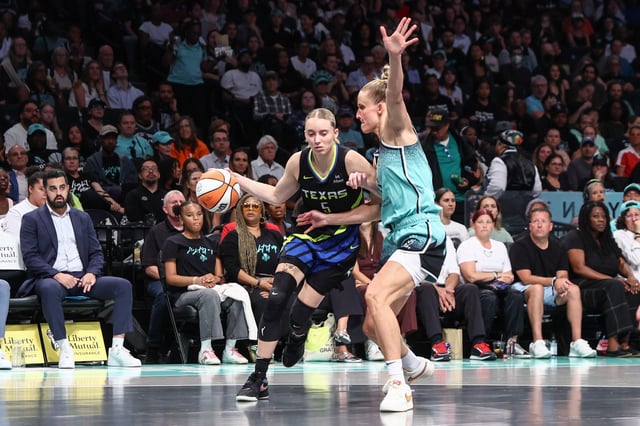 Aug 5, 2025; Brooklyn, New York, USA;  Dallas Wings guard Paige Bueckers (5) looks to drive past New York Liberty forward Leonie Fiebich (13) in the second quarter at Barclays Center. Mandatory Credit: Wendell Cruz-Imagn Images