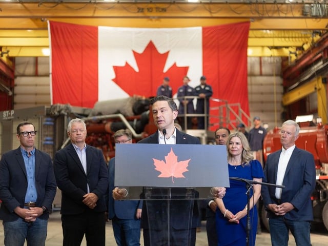 Conservative leader Pierre Poilievre, flanked by members of parliament, speaks in front of workers and a fracking pump at EnQuest Energy Solutions in Calgary on Thursday, August 7, 2025. 