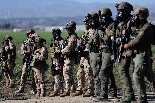 U.S. federal agents stand guard while blocking a road leading to an agricultural facility where U.S. federal agents and immigration officers carried out an operation, in Camarillo, California, U.S., July 10, 2025. REUTERS/Daniel Cole/File Photo