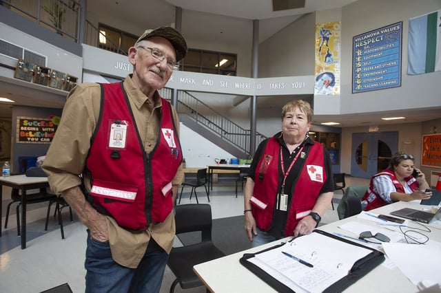 Red Cross volunteers are seen at the Villa Nova Junior High registration centre for those displaced by the Holyrood fire, in Topsail, N.L., on Thursday, Aug. 7, 2025. THE CANADIAN PRESS/Paul Daly