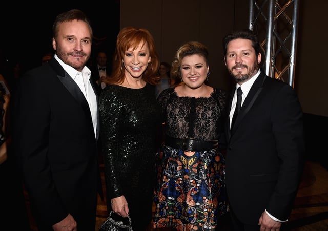 Narvel Blackstock, from left, singers Reba McEntire and Kelly Clarkson, and Clarkson's then-husband Brandon Blackstock attend Muhammad Ali's Celebrity Fight Night XXI at the JW Marriott Phoenix Desert Ridge Resort & Spa in Phoenix on March 28, 2015.