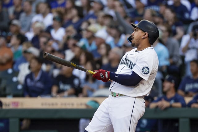 Aug 6, 2025; Seattle, Washington, USA; Seattle Mariners first baseman Josh Naylor (12) hits a two-run home run against the Seattle Mariners during the first inning at T-Mobile Park. Mandatory Credit: Joe Nicholson-Imagn Images
