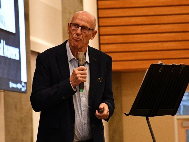 Mitch Sylvestre, CEO of Alberta Prosperity Project displays an image taken during the Holocaust while drawing comparisons between the current economic situation in Alberta and Nazi Germany. Sylvestre spoke at an event hosted by the Alberta Prosperity Project on Tuesday, March 18, 2025, in Strathcona County. 