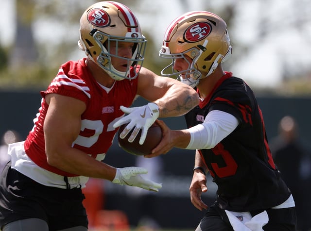San Francisco 49ers starting quarterback Brock Purdy (13) hands the ball off to San Francisco 49ers’ Christian McCaffrey (23) during practice at the 49ers training camp at the practice facility at Levi’s Stadium in Santa Clara, Calif., on Wednesday, July 23, 2025. (Nhat V. Meyer/Bay Area News Group)