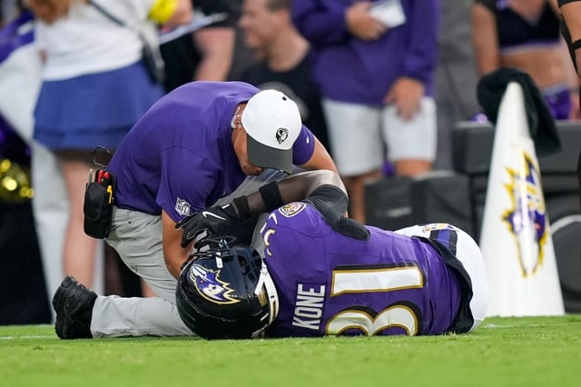 Ravens cornerback Bilhal Kone lays on the ground after injuring his leg against the Colts. (Alex Brandon/AP)