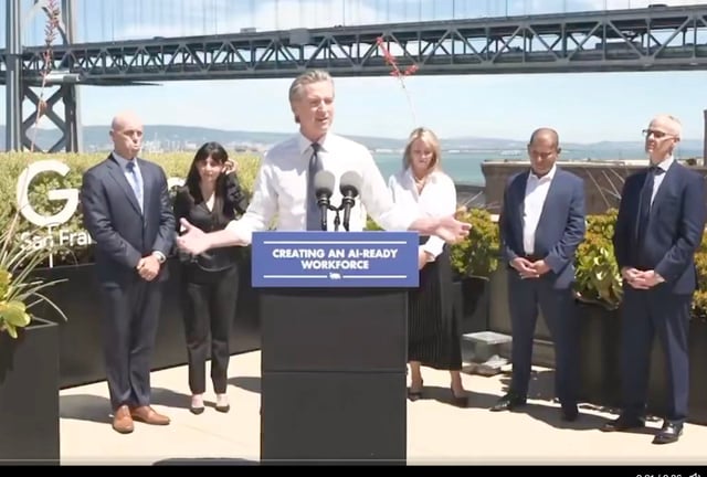 Gov. Gavin Newsom speaks Thursday, Aug. 7 on top of Google’s waterfront building in San Francisco, Calif., with college and AI-industry leaders behind him (screenshot of live-streamed press conference)