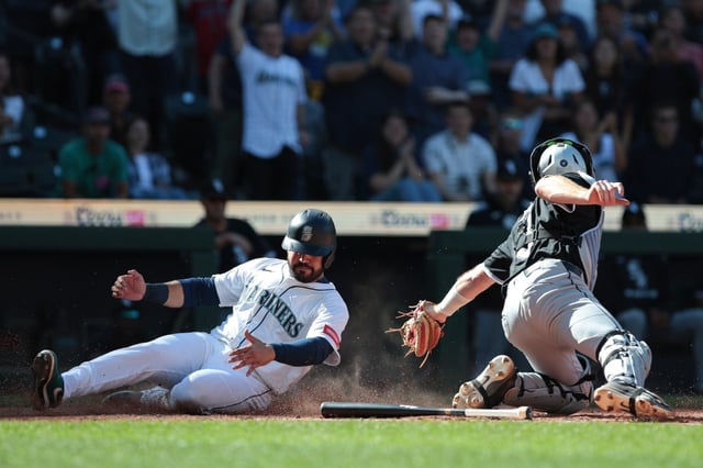 Mariners third baseman Eugenio Suárez, left, beats a tag by White Sox catcher Kyle Teel to score the winning run during the 11th inning on Thursday, Aug. 7, 2025, in Seattle. The Sox lost 4-3. (Jason Redmond/AP)