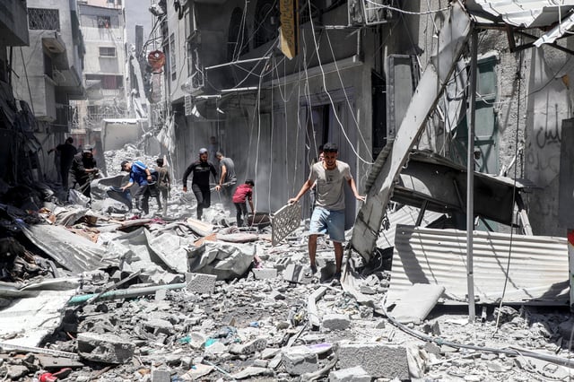 Palestinians check the rubble of destroyed houses after an Israeli airstrike in Gaza City, on May 31, 2025.