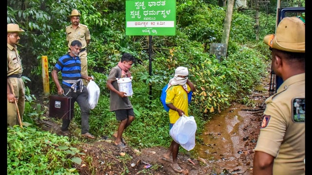 Workers leave from a site of an alleged burial related to the Dharmasthala mass burial case, at Dharmasthala, in Dakshina Kannada district. (PTI PHOTO)