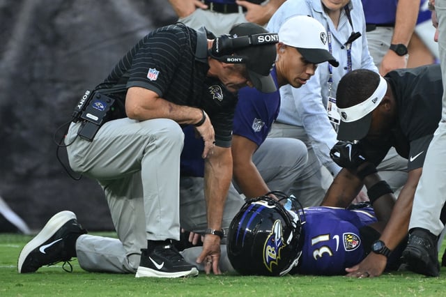 Aug 7, 2025; Baltimore, Maryland, USA; Baltimore Ravens head coach John Harbaugh (left) checks on Baltimore Ravens cornerback Bilhal Kone (31) who was injured on the play against the Indianapolis Colts during the first quarter at M&T Bank Stadium. Mandatory Credit: Rafael Suanes-Imagn Images