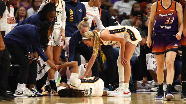 Aug 7, 2025; Phoenix, Arizona, USA; Indiana Fever guard Sydney Colson (51) reacts after suffering an injury alongside Phoenix Mercury guard Sami Whitcomb (33) in the first half of a WNBA game at PHX Arena. Mandatory Credit: Mark J. Rebilas-Imagn Images