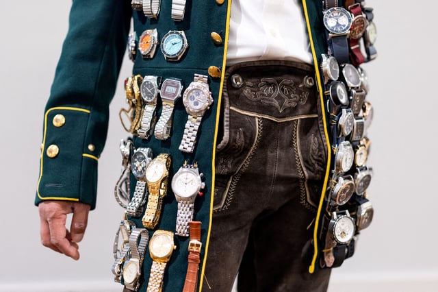 A visitor with several watches strapped to his blazer is pictured at the Watches and Wonders fair in Geneva, Switzerland, April 9, 2024. REUTERS/Pierre Albouy/File Photo