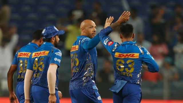 Tymal Mills (centre) celebrates with MI players