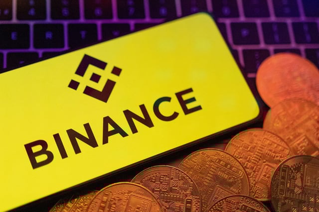 Smartphone with displayed Binance logo and representation of cryptocurrencies are placed on a keyboard in this illustration taken, June 8, 2023. REUTERS/Dado Ruvic/Illustration/ File Photo
