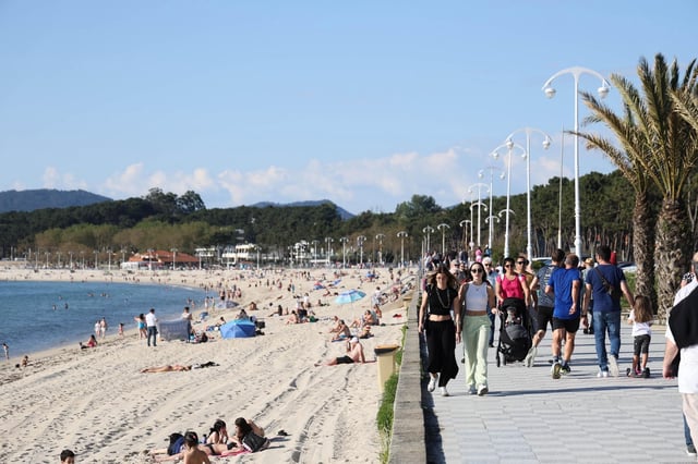 Una multitud de personas pasean por la playa de Samil, en Vigo.