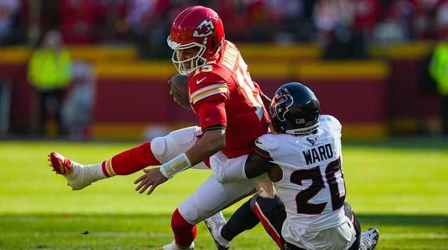 Dec 21, 2024; Kansas City, Missouri, USA; Kansas City Chiefs quarterback Patrick Mahomes (15) is tackled by Houston Texans safety Jimmie Ward (20) during the first half at GEHA Field at Arrowhead Stadium. Mandatory Credit: Jay Biggerstaff-Imagn Images
