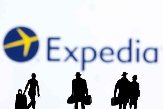 Figurines are seen in front of the Expedia logo in this illustration taken February 27, 2022. REUTERS/Dado Ruvic/Illustration