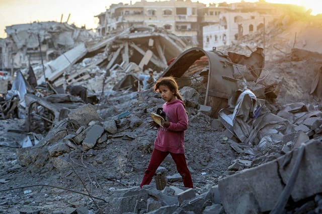 Palestinians, living at a school, gather to inspect the site after Israeli forces hit a health facility belonging to the United Nations Relief and Works Agency for Palestine Refugees in the Near East (UNRWA), located in the Sheikh Ridwan neighborhood in Gaza City, Gaza on August 06, 2025. It has been reported that there are casualties and injuries following the attack.