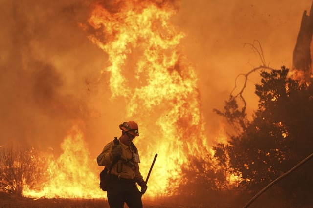 A firefighter battles the Canyon Fire on Thursday, Aug. 7, 2025, in Hasley Canyon, Calif. (AP Photo/Marcio Jose Sanchez)
