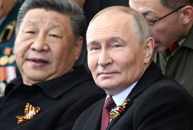 Russian President Vladimir Putin and his Chinese counterpart Xi Jinping attend a military parade on Victory Day, marking the 80th anniversary of the victory over Nazi Germany in World War Two, in Red Square in central Moscow, Russia, May 9, 2025. Sergei Bobylyov/Host agency RIA Novosti/Handout via REUTERS/File Photo
