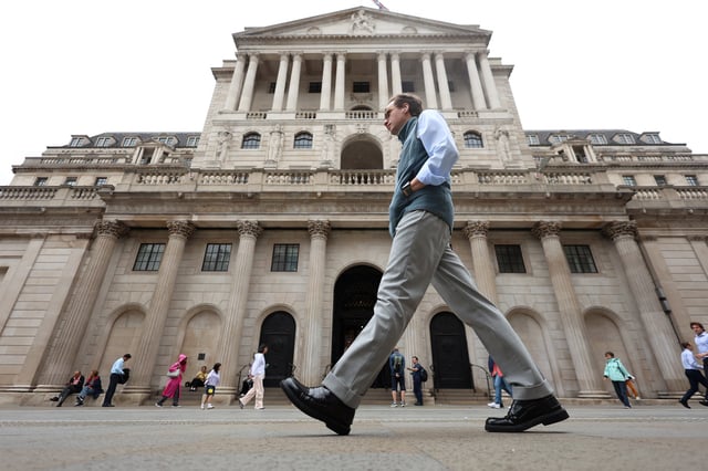A man walks past the Bank of England building in London, Britain, August 4, 2025. REUTERS/Hiba Kola/File Photo