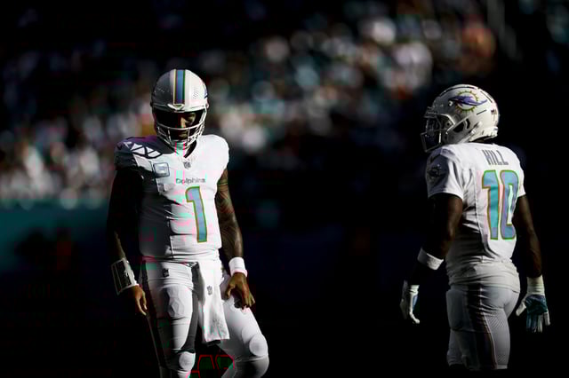 MIAMI GARDENS, FLORIDA - DECEMBER 08: Tua Tagovailoa #1 and Tyreek Hill #10 of the Miami Dolphins look on during an NFL football game against the New York Jets at Hard Rock Stadium on December 08, 2024 in Miami Gardens, Florida