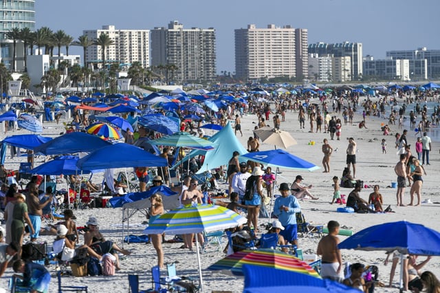 Beachgoers are on a very hot day at Clearwater Beach, Fla., on July 26, 2025.