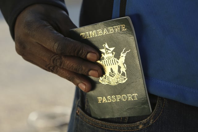 A man holding a Zimbabwean passport in Harare, Friday, June 14, 2019. The U.S. has paused all routine visa applications from the country.