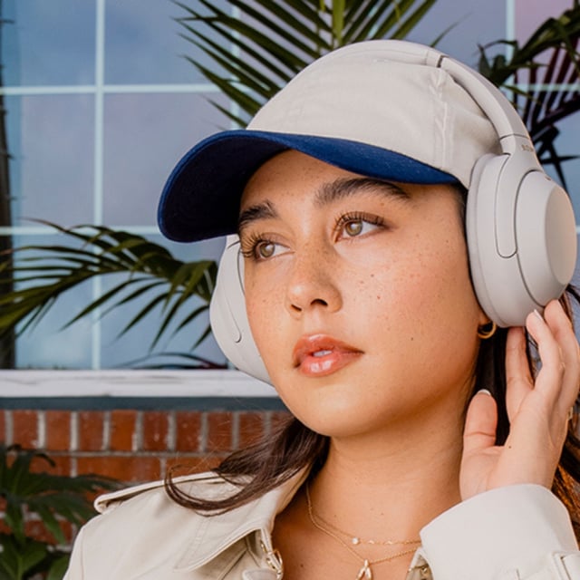 woman wearing Sony WH-1000XM4 headphones