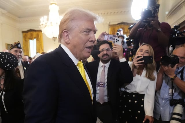 President Donald Trump departs an event to mark National Purple Heart Day in the East Room of the White House, Thursday, Aug. 7, 2025, in Washington. (AP Photo/Mark Schiefelbein)