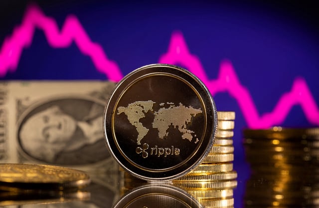 A representations of cryptocurrency Ripple is seen in front of a stock graph and U.S. dollar in this illustration taken, January 24, 2022. REUTERS/Dado Ruvic/Illustration/File Photo