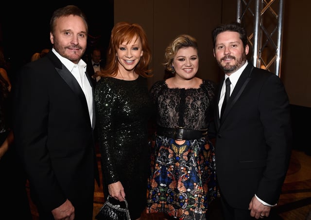 Reba McEntire (center left) and Kelly Clarkson (center right) with McEntire's ex-husband Narvel Blackstock and his son Brandon Blackstock, the ex-husband of Clarkson.