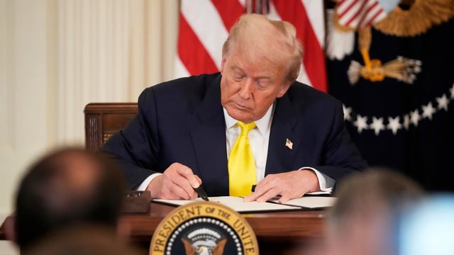 President Donald Trump signs a proclamation declaring National Purple Heart Day in the East Room of the White House