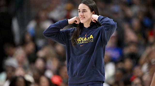 Fever guard Caitlin Clark (22) walks on to the court during the second half against the Dallas Wings at the American Airlines Center