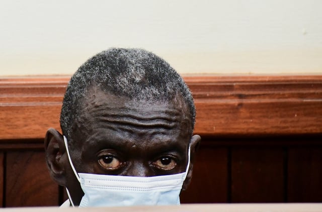 Uganda's four-time presidential candidate Kizza Besigye sits in the dock where he was charged with treason alongside his colleague Obeid Lutale and Captain Denis Oola at the Chief Magistrate Court in Nakawa suburb of Kampala, Uganda, February 21, 2025. REUTERS/Abubaker Lubowa/File Photo