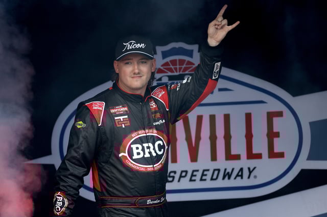 Brenden Queen, driver of the #1 Best Repair Company Toyota, waves to fans as he walks onstage during driver intros before the NASCAR Craftsman Truck Series Rackley Roofing 200 at Nashville Superspeedway on June 28, 2024 in Lebanon, Tennessee.