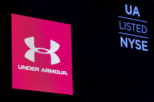 The ticker symbol and company logo for Under Armour, Inc. is displayed on a screen on the floor of the New York Stock Exchange (NYSE) in New York, U.S., January 22, 2019. REUTERS/Brendan McDermid/File Photo
