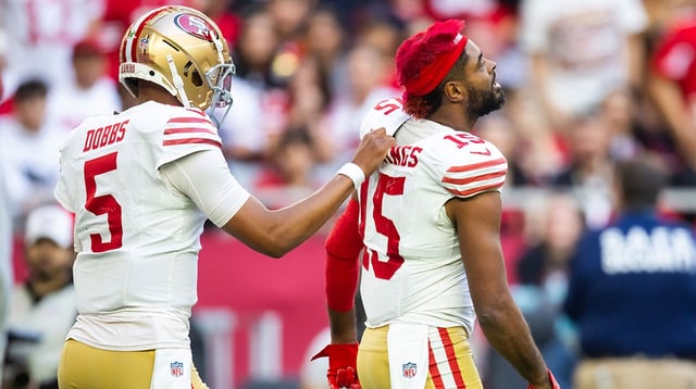Jan 5, 2025; Glendale, Arizona, USA; San Francisco 49ers wide receiver Jauan Jennings (15) is led away from a fight by quarterback Joshua Dobbs (5) against the Arizona Cardinals in the first half at State Farm Stadium.