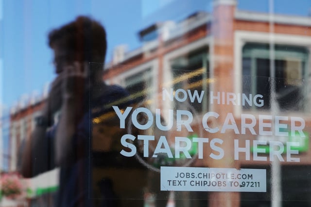 A Chipotle restaurant advertises it is hiring in Cambridge, Massachusetts, U.S., August 28, 2023. REUTERS/Brian Snyder/File Photo