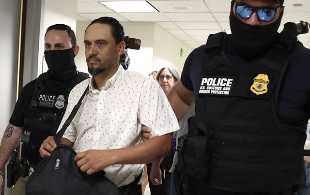 Federal agents detain a man as he exits a court hearing in immigration court at the Jacob K. Javitz Federal Building on August 5, 2025 in New York City.