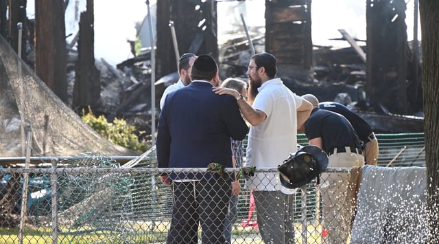 Rabbi Yitzchok Lerman, who survived with his family in the fire that completely destroyed Congregation Beth El synagogue, stands in front of the synagogue's ruins in Rutherford, New Jersey on August 8. (Kyle Mazza/Anadolu via Getty Images)