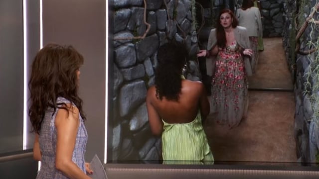 A woman is talking to the corner of a screen as another woman looks on
