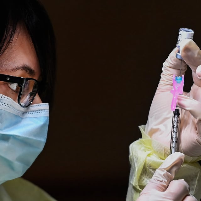 Francesca Paceri, a registered pharmacist technician carefully fills the Pfizer-BioNTech COVID-19 mRNA vaccine at a vaccine clinic during the COVID-19 pandemic in Toronto on Tuesday, December 15, 2020. THE CANADIAN PRESS/Nathan Denette