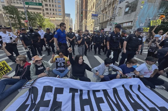 Immigrants' rights advocates blocked traffic outside 26 Federal Plaza in Lower Manhattan on Friday. They decried tactics used by Immigration and Customs Enforcement agents and alleged woeful conditions in temporary holding for immigrants being used by ICE.