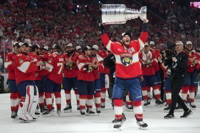 Jun 17, 2025; Sunrise, Florida, USA; Florida Panthers left wing Matthew Tkachuk (19) hoist the Stanley Cup after game six of the 2025 Stanley Cup Final against the Edmonton Oilers at Amerant Bank Arena. Mandatory Credit: Jim Rassol-Imagn Images/File Photo